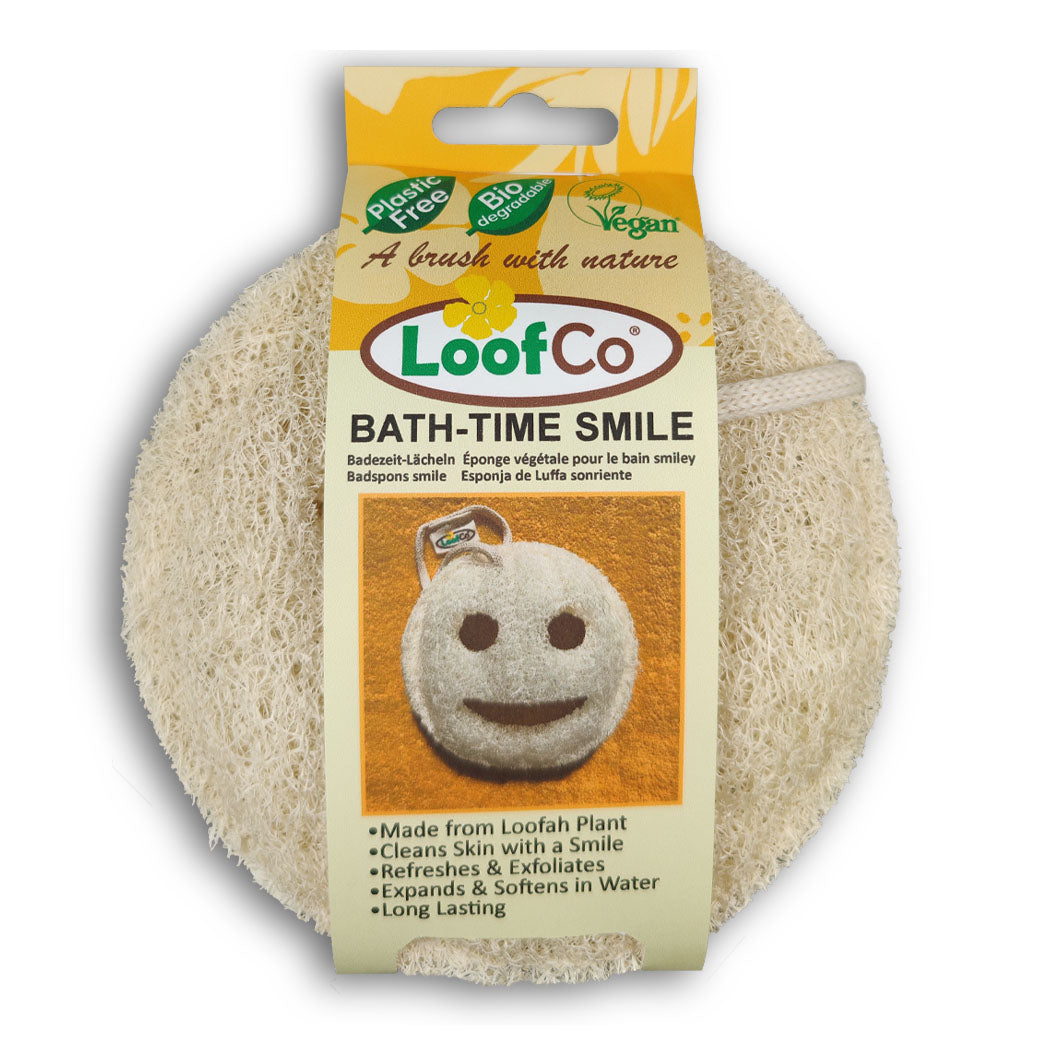 LoofCo Bath-Time Smile in packaging on white background- a playful smiley faced shaped loofah pad for gentle exfoliation