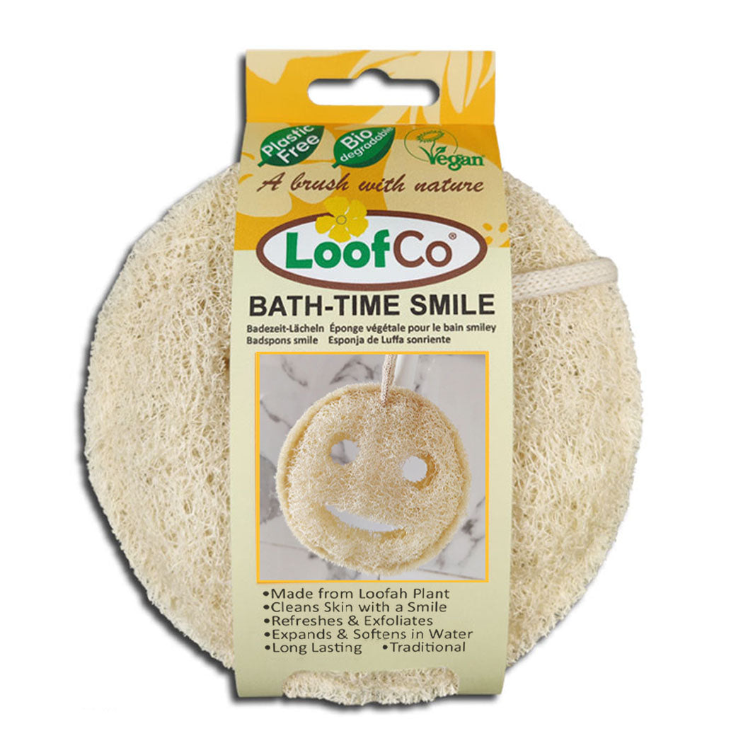 LoofCo Bath-Time Smile in packaging on white background- a playful smiley faced shaped loofah pad for gentle exfoliation
