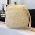 LoofCo Cleaning Pad loofah sponge on a kitchen sink with tap in the background
