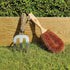 LoofCo Gardener's Brush next to box bush and gardening fork
