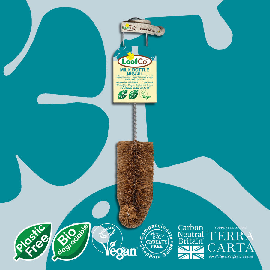 LoofCo milk bottle brush on a blue and green abstract background with branding logos.