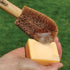 Person holding a LoofCo washing-Up Brush with coir bristles against a lemongrass Washing-Up Soap Bar on a green background