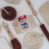 Collection of LoofCo cleaning tools including brushes and sponges on a white background