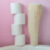 Stack of white toilet paper rolls and a beige LoofCo Whole loofah against a pink background