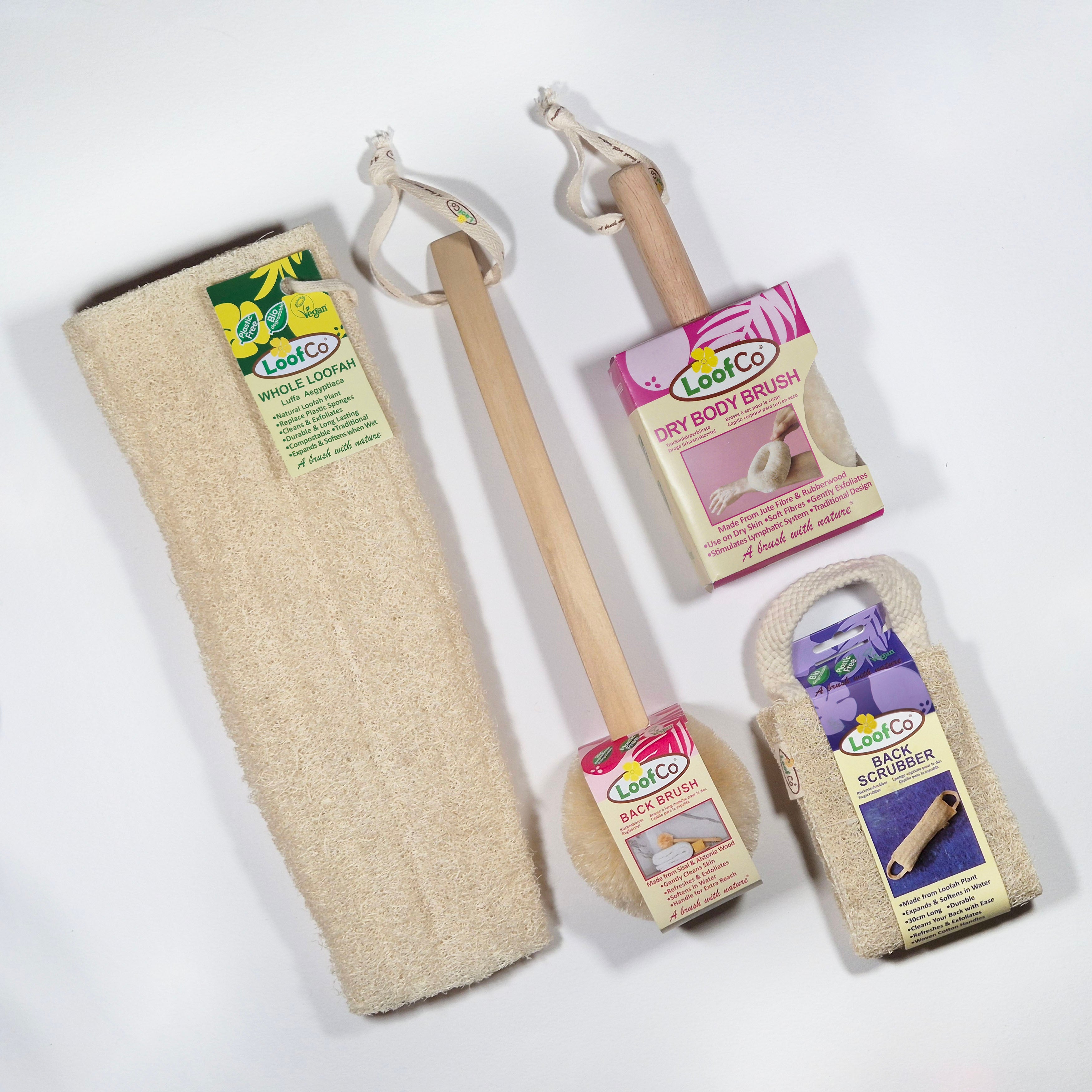 Set of LoofCo body products including a long-handled back brush, back scrubber, and drybody brush with packaging on a white background.