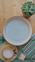 LoofCo coconut coir washing-up brush cleaning a mug, cutlery and plates.