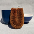 Unlabelled LoofCo washing-Up Brush next to blue cup and bowl